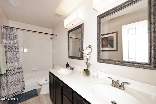 full bathroom with vanity, toilet, shower / bath combo with shower curtain, and hardwood / wood-style flooring