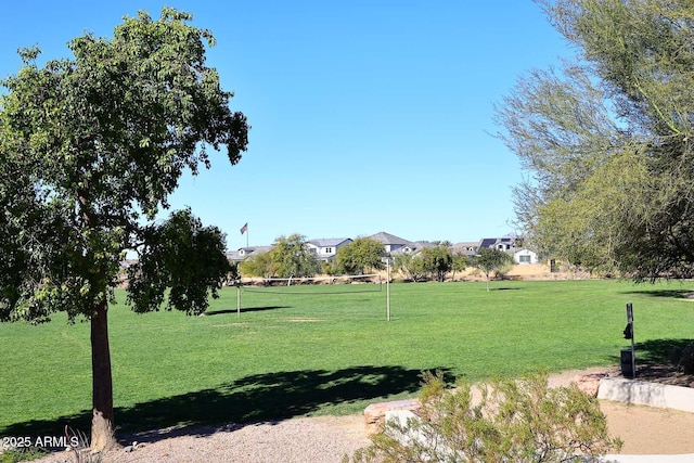 view of community featuring volleyball court and a yard