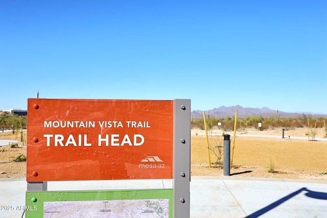 community sign with a mountain view