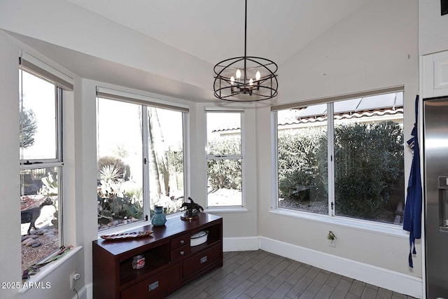 unfurnished sunroom featuring a notable chandelier and vaulted ceiling