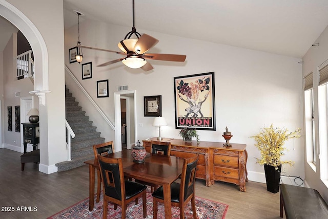 dining space featuring hardwood / wood-style flooring, high vaulted ceiling, and ceiling fan