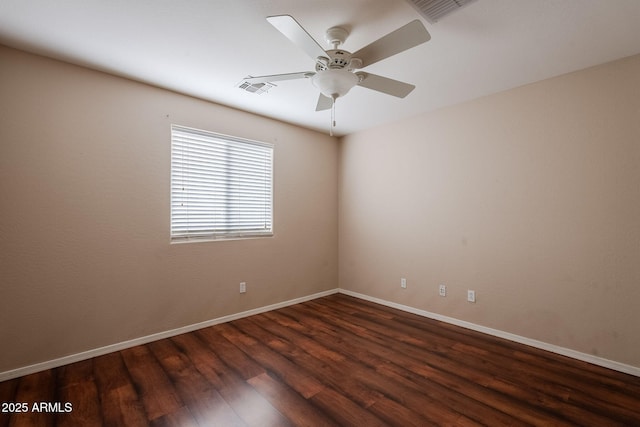 empty room featuring dark wood-type flooring and ceiling fan