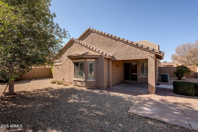 rear view of property with a patio and central AC