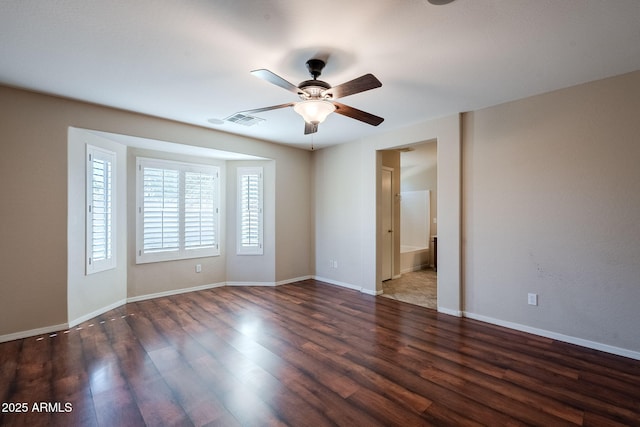 empty room with dark hardwood / wood-style floors and ceiling fan