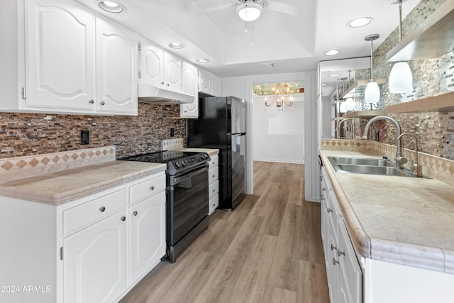 kitchen with ceiling fan with notable chandelier, white cabinetry, decorative light fixtures, black appliances, and sink