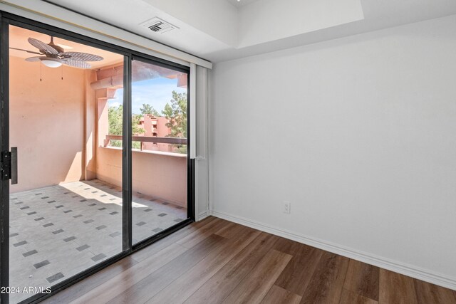 unfurnished room with ceiling fan and wood-type flooring