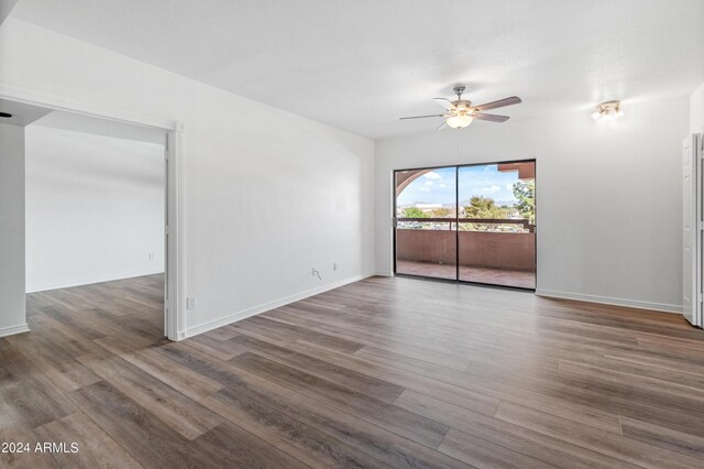 spare room featuring ceiling fan and hardwood / wood-style flooring