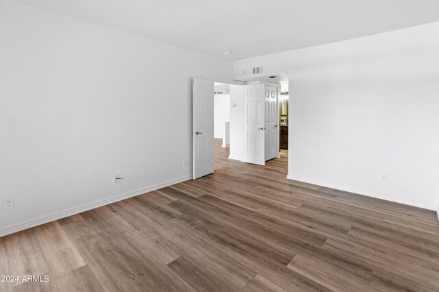 spare room with wood-type flooring