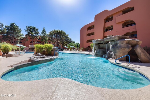 view of pool featuring pool water feature