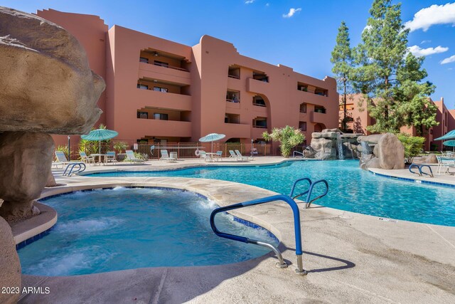 view of swimming pool featuring pool water feature and a patio area