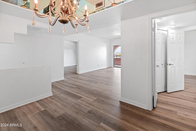 empty room with ceiling fan and hardwood / wood-style flooring