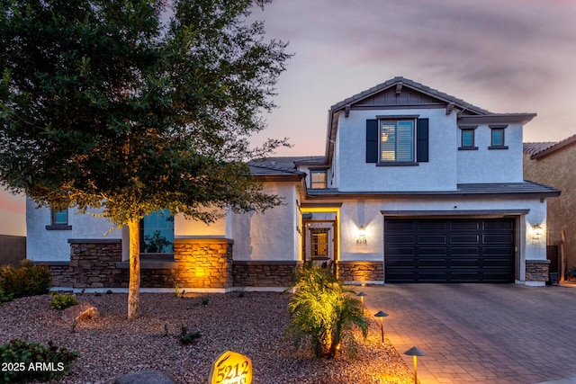 5212 S Seton Ct, Gilbert, AZ 85298 - view of front of property featuring stone siding, a garage, decorative driveway, and stucco siding