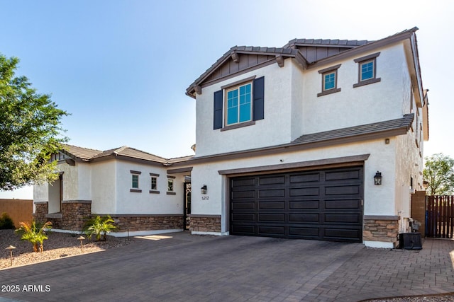 5212 S Seton Ct, Gilbert, AZ 85298 - view of front of home with stone siding, an attached garage, stucco siding, and decorative driveway