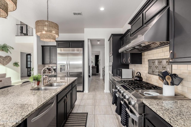 5212 S Seton Ct, Gilbert, AZ 85298 - kitchen featuring extractor fan, a sink, premium appliances, tasteful backsplash, and light stone countertops