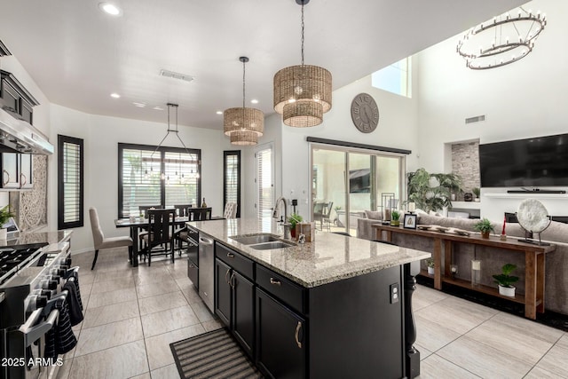 5212 S Seton Ct, Gilbert, AZ 85298 - kitchen with stainless steel appliances, a sink, dark cabinetry, open floor plan, and pendant lighting