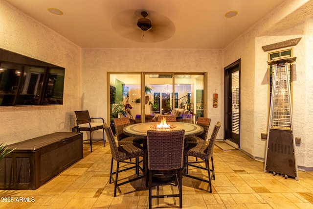 5212 S Seton Ct, Gilbert, AZ 85298 - dining space featuring a textured wall, stone tile floors, and ceiling fan