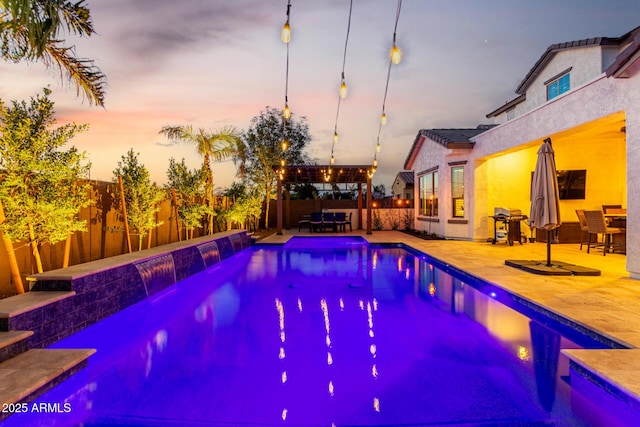 5212 S Seton Ct, Gilbert, AZ 85298 - pool at dusk with a fenced backyard, a patio area, and area for grilling