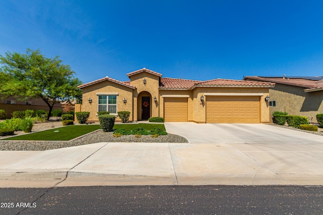 mediterranean / spanish-style house featuring an attached garage, a tiled roof, concrete driveway, and stucco siding