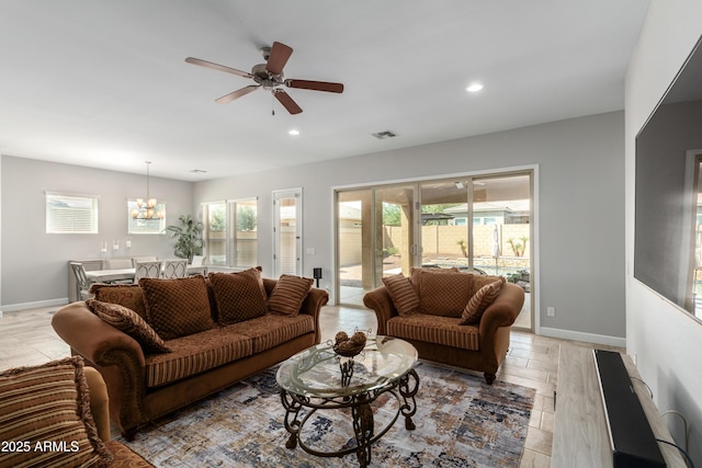 living room with recessed lighting, visible vents, plenty of natural light, and baseboards