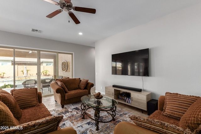 living room featuring ceiling fan, stone finish flooring, visible vents, and recessed lighting