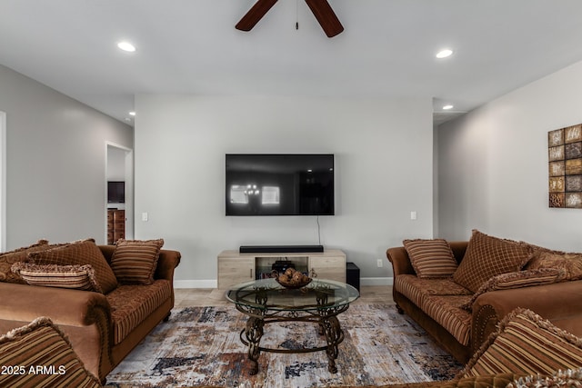 living area featuring baseboards, a ceiling fan, and recessed lighting