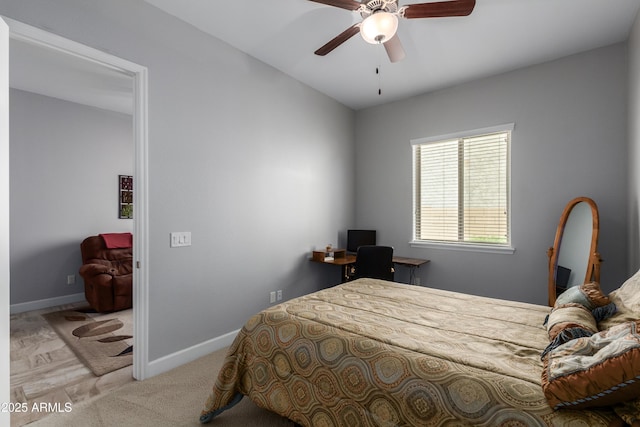 bedroom with a ceiling fan, baseboards, and carpet flooring