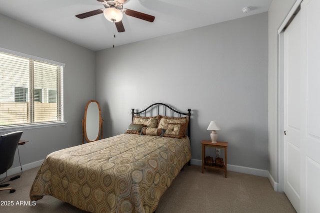 bedroom with a ceiling fan, a closet, baseboards, and carpet flooring