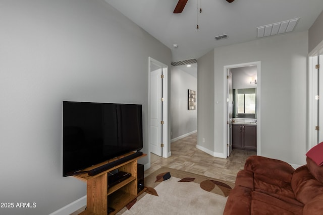 living area featuring a ceiling fan, visible vents, and baseboards