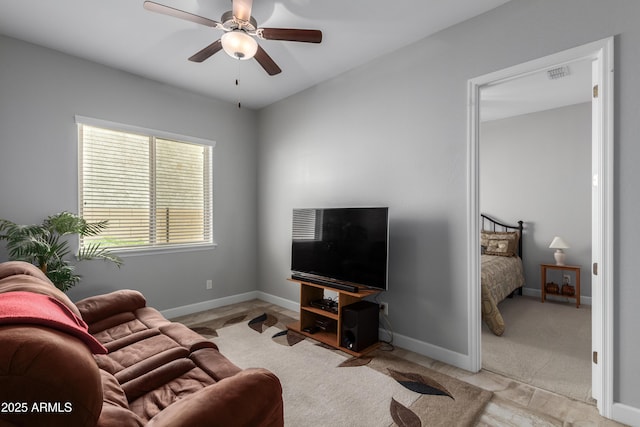 living room featuring ceiling fan, visible vents, and baseboards