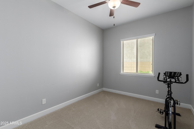 exercise room with ceiling fan, baseboards, and light colored carpet