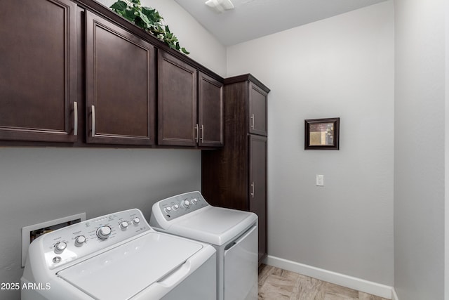 laundry room featuring cabinet space, baseboards, and separate washer and dryer