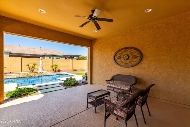 view of patio with a ceiling fan, a fenced in pool, and a fenced backyard