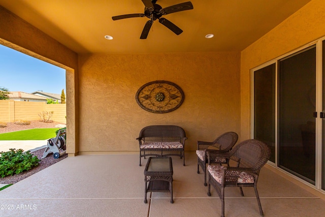 view of patio featuring ceiling fan and fence