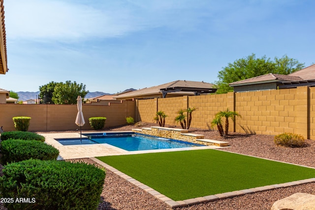 view of pool featuring a lawn, a fenced backyard, a fenced in pool, and a patio area