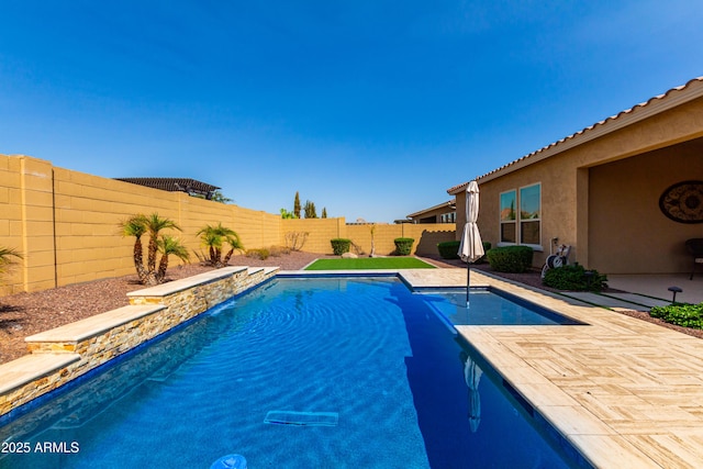 view of swimming pool with a fenced backyard, a patio, and a fenced in pool