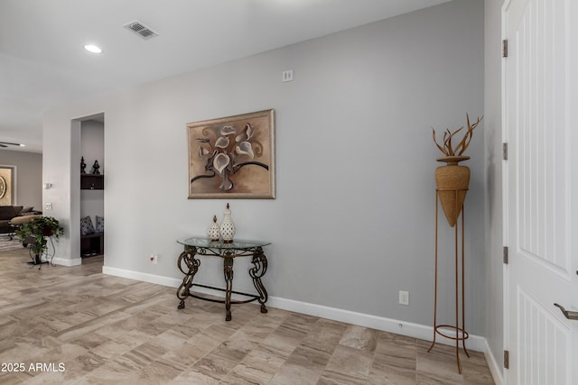 corridor featuring recessed lighting, visible vents, and baseboards