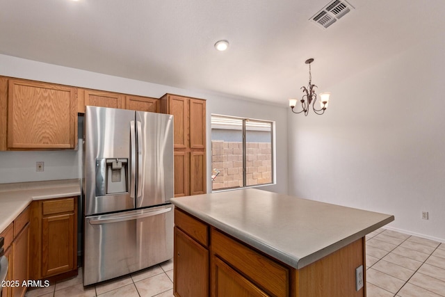 4143 E Sundance Ave, Gilbert, AZ 85297 - kitchen featuring stainless steel refrigerator with ice dispenser, light tile patterned flooring, a chandelier, and brown cabinets