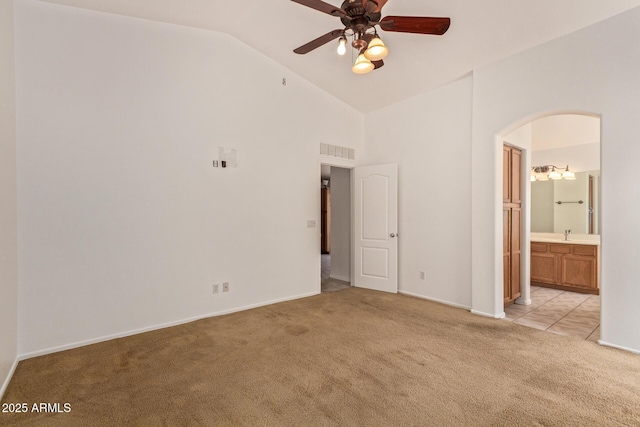 4143 E Sundance Ave, Gilbert, AZ 85297 - unfurnished bedroom featuring light carpet, arched walkways, ensuite bathroom, baseboards, and high vaulted ceiling