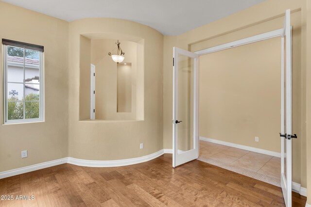 1620 E Sattoo Way, Queen Creek, AZ 85140 - unfurnished room featuring wood finished floors, baseboards, and french doors