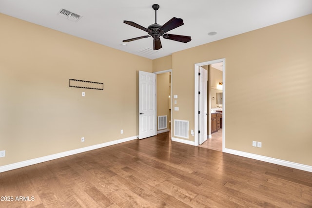 1620 E Sattoo Way, Queen Creek, AZ 85140 - unfurnished bedroom with wood finished floors, baseboards, connected bathroom, and a ceiling fan