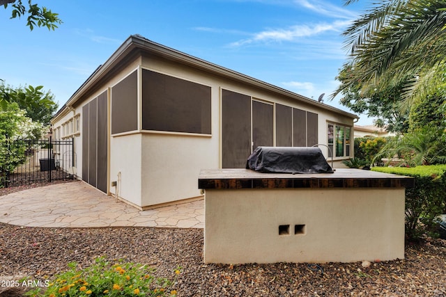 1620 E Sattoo Way, Queen Creek, AZ 85140 - back of property with a patio area, area for grilling, fence, a sunroom, and stucco siding