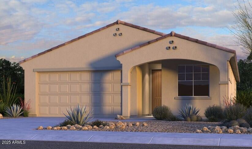 mediterranean / spanish house with concrete driveway, an attached garage, and stucco siding