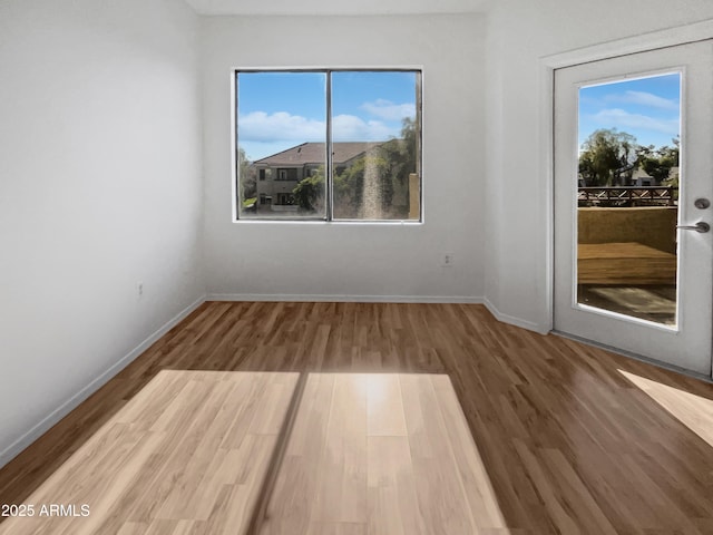 unfurnished room with hardwood / wood-style floors