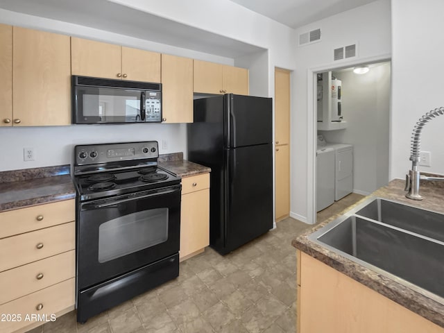 kitchen with black appliances, separate washer and dryer, sink, and light brown cabinetry