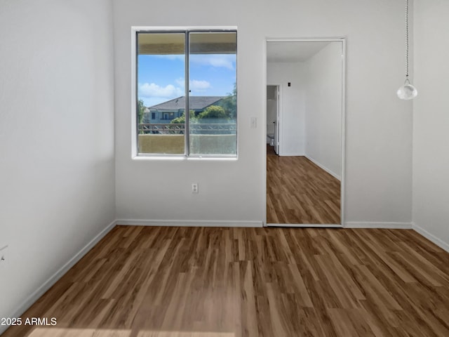 unfurnished bedroom featuring dark hardwood / wood-style flooring