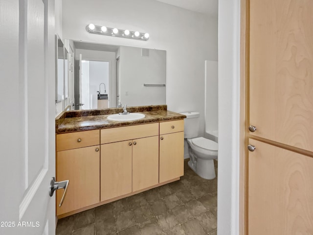 bathroom featuring vanity and toilet