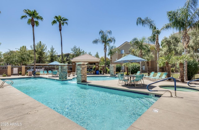 view of pool featuring a gazebo, a patio, and a hot tub