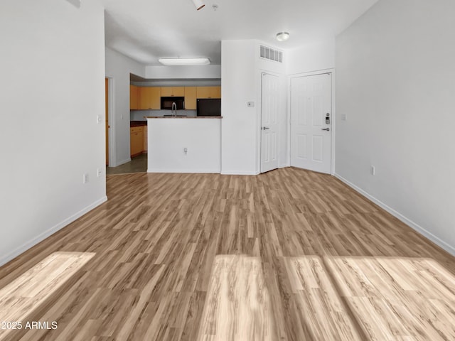 unfurnished living room featuring light hardwood / wood-style floors