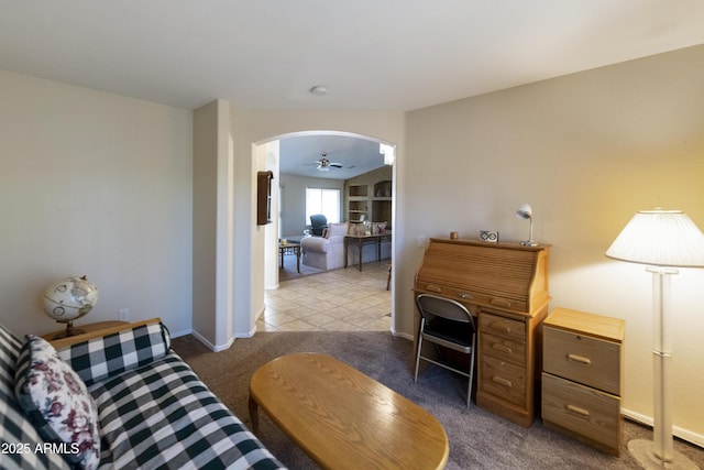 interior space with ceiling fan and carpet flooring