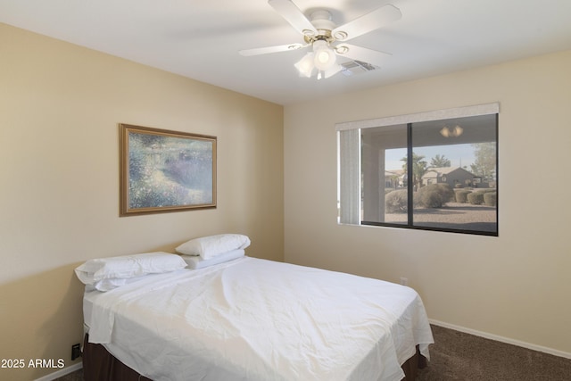 bedroom with ceiling fan and dark colored carpet